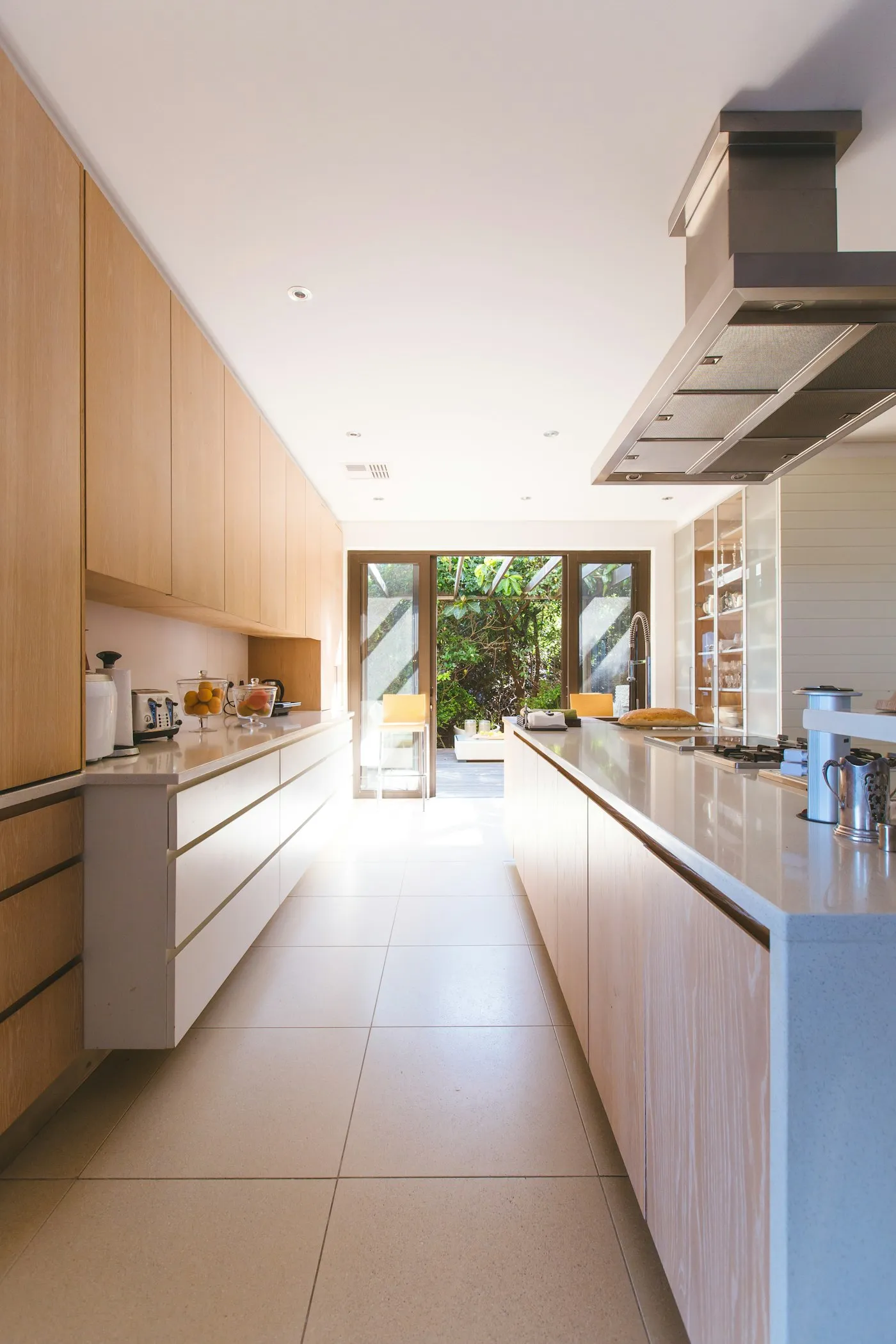 White kitchen with an island and a glass-panel door