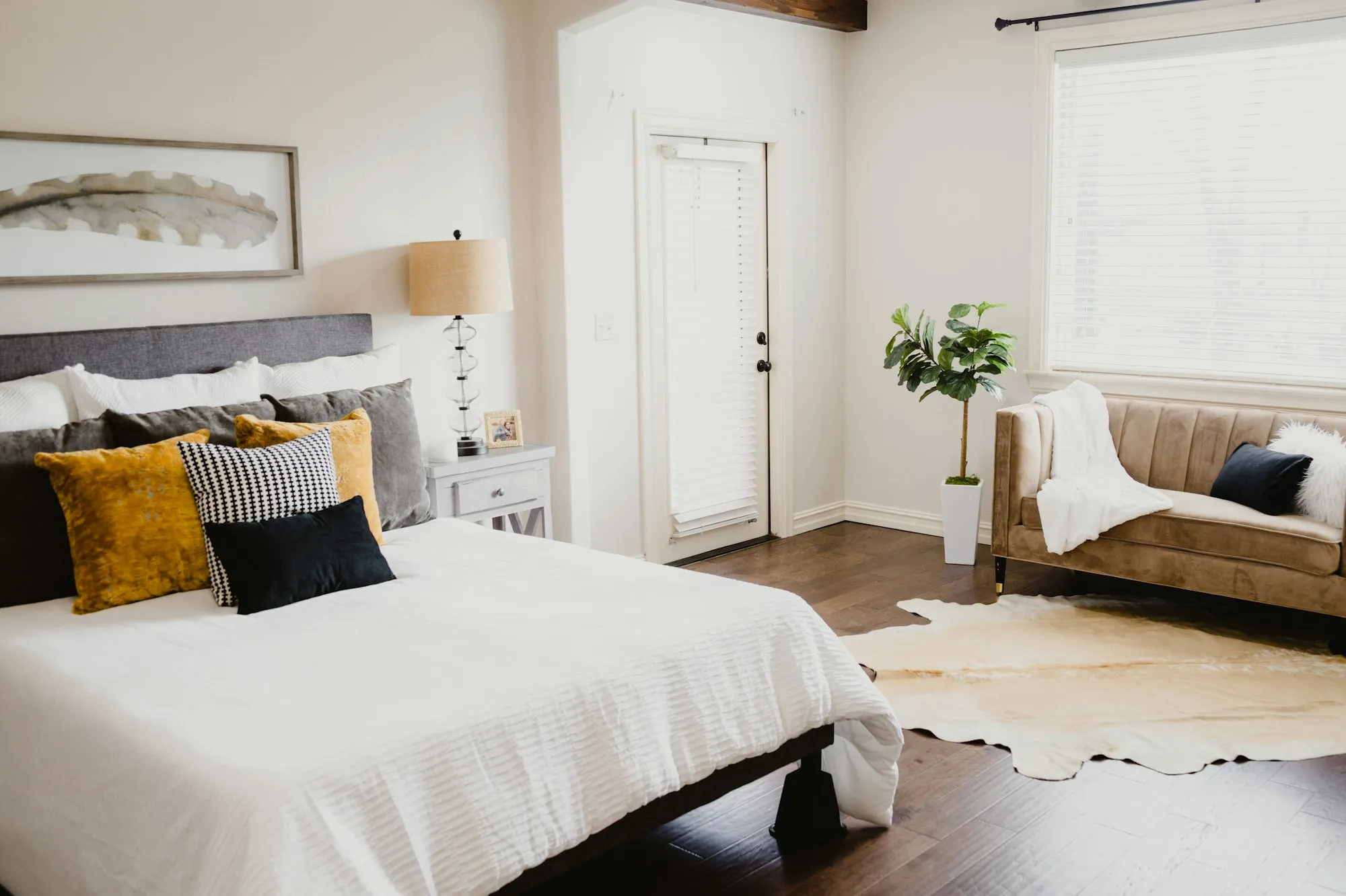 Bedroom with white bed linen beside a white wooden door