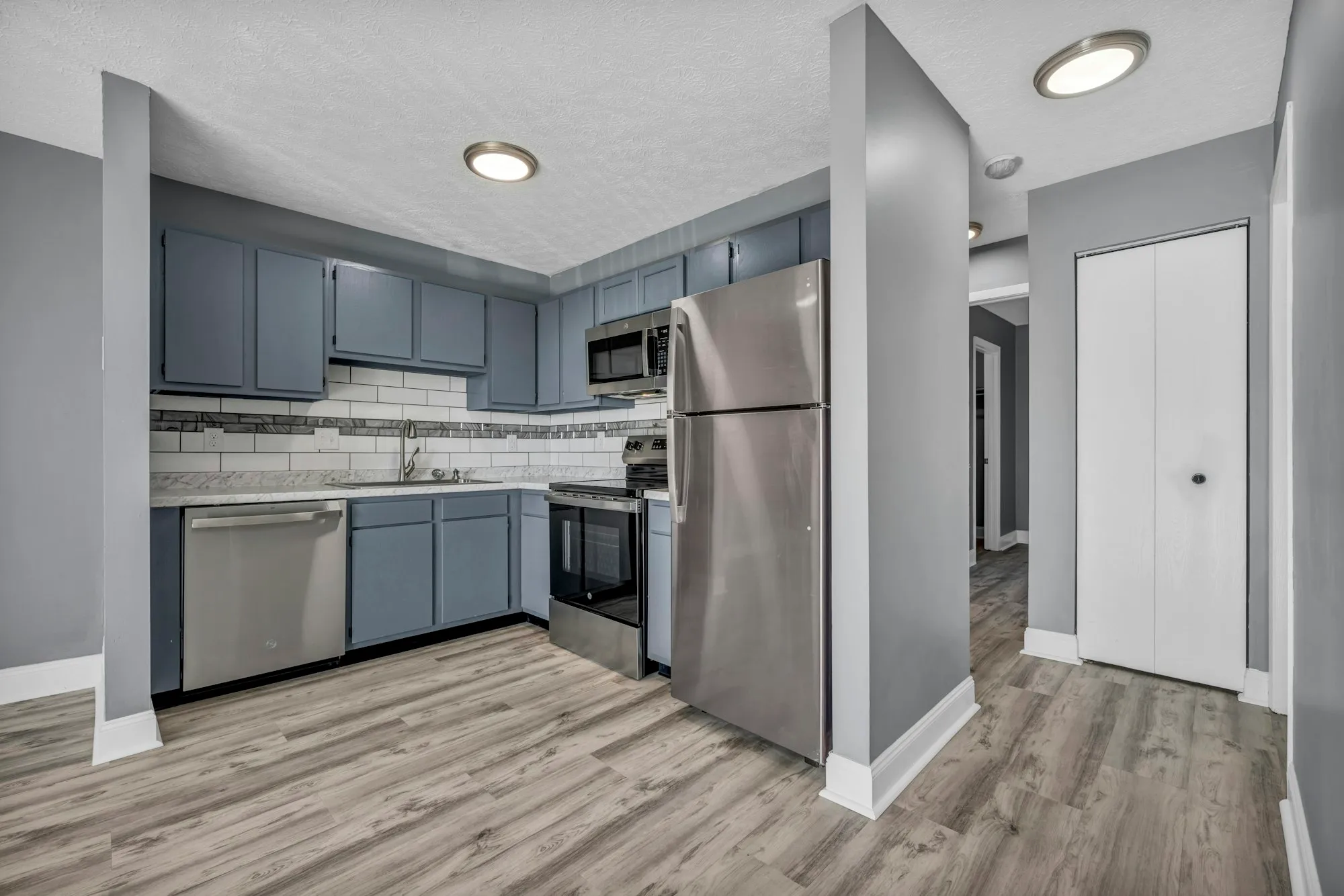 Kitchen with stainless steel appliances and light wood floors