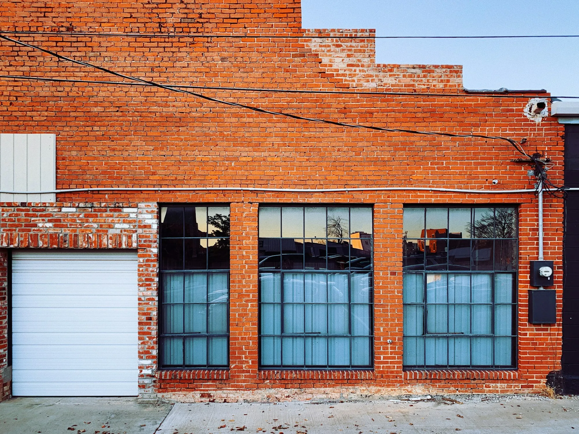 Brick commercial building with tall glass windows