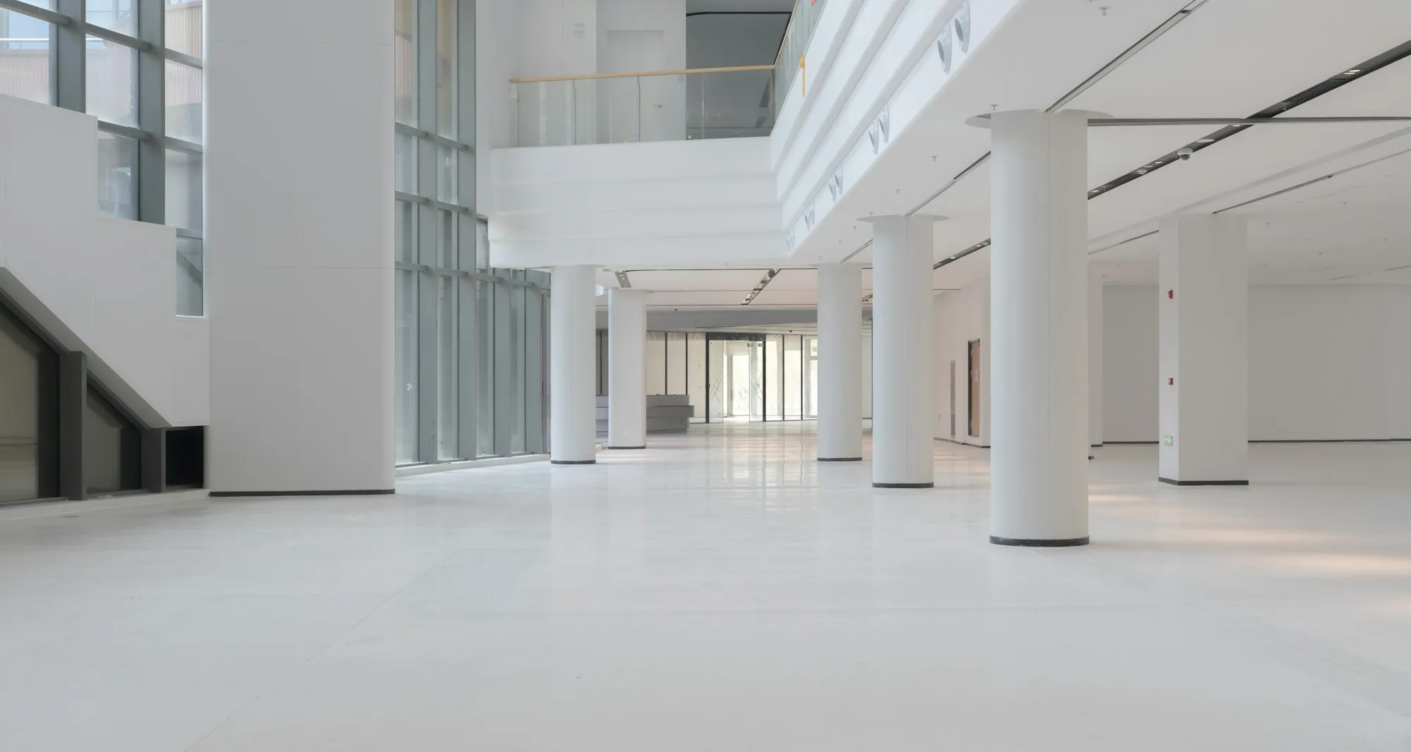 Bright open floor with columns and large windows